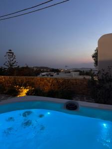 a swimming pool with a view of the sunset at Mykonos Lagom in Mýkonos City