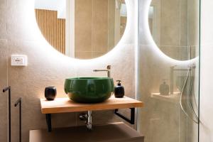 a bathroom with a green sink and a mirror at Dimoradipa in Santa Maria di Castellabate +124 photos