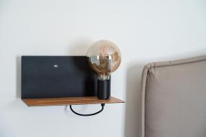 a lamp on a wall next to a chair at Dimoradipa in Santa Maria di Castellabate