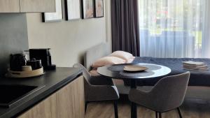 a kitchen with a table and chairs in a room at Butas su terasa in Šventoji