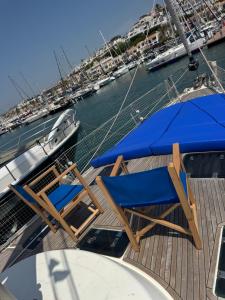 una terraza con sillas y sombrillas en un barco en Beverflor des mers, en Sitges