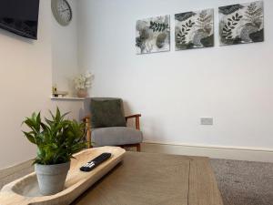 a living room with a table with a remote control on it at ResiLets - Stanley House - Large, Modern 3 Bed - NEW! in Blythe