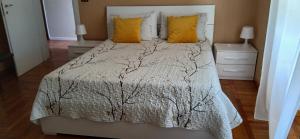 a bedroom with a large bed with yellow pillows at Casa Germana in Invorio Inferiore