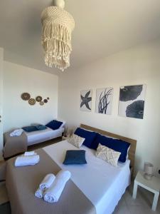 a bedroom with two beds and a chandelier at Aquamaris in Giovinazzo +45 photos