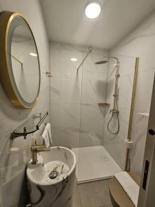 a bathroom with a sink and a shower with a mirror at Apartments Lusi in Brela