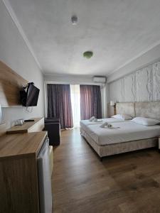 Postel nebo postele na pokoji v ubytování Hotel Pini