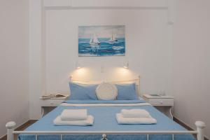 a bedroom with a blue bed with two towels at Aurea Blu Studio 05, Experience nature, relax, dream in Aliko Beach