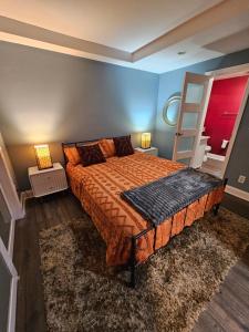 a bedroom with a bed and two lamps and a ladder at Private Jacuzzi at Piedmont Park in Atlanta