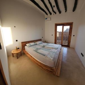 a bedroom with a large bed and a window at Villa Ark Zanzibar in Paje