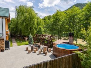 a backyard with a hot tub and a playground at Buturuga Mică in Nehoiu