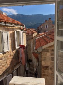 a view of an alley with buildings and roofs at Budva Old City Central Studio Private in Budva