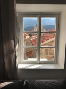 a window in a room with a view of a city at Budva Old City Central Studio Private in Budva