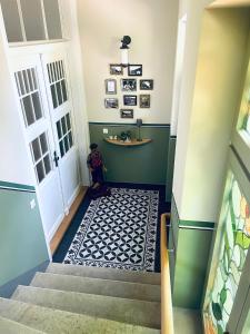 a room with a staircase with a blue and white floor at Ferienwohnung Villa Grützner in Freital