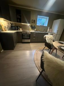 a large kitchen with a table and a couch in it at Lofoten Retreat Apartment in Leknes