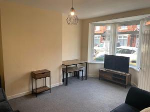 a living room with a desk and a window at ResiLets - Modern Central Town Centre Apartment - Sleeps 4! in Blythe