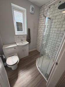 a bathroom with a shower and a toilet and a sink at ResiLets - Modern Central Town Centre Apartment - Sleeps 4! in Blythe