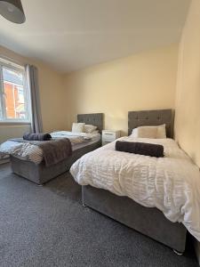 two beds sitting in a room with at ResiLets - Modern Central Town Centre Apartment - Sleeps 4! in Blythe