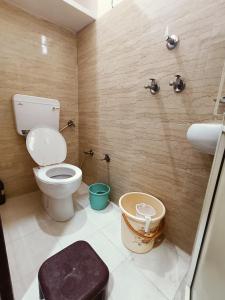 a bathroom with a toilet and a sink at Sankalp Yatri Nivas AC dormitory in Gwalior