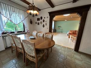 a dining room with a wooden table and chairs at Ferienwohnung "FeWo am Bach" - Pegnitz in Pegnitz