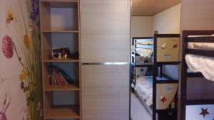 a small room with a bunk bed and a closet at Butas Nidoje in Nida
