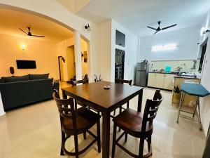 a dining room and living room with a table and chairs at Corundum Twins in Arpora, 5 mins to Baga Calangute in Arpora