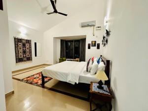 a bedroom with a bed and a ceiling fan at Corundum Twins in Arpora, 5 mins to Baga Calangute in Arpora +27 photos