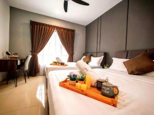 a hotel room with two beds and a desk at Ipoh Manhattan Waterpark 3BR Suite by City Home Empire MHB509 in Ipoh +55 photos