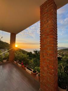 a view of a sunset from the balcony of a house at Grand Seaview Apartments in Ksamil