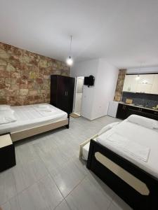 a room with two beds and a kitchen at Grand Seaview Apartments in Ksamil
