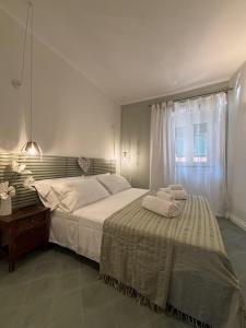 a bedroom with a bed with two towels on it at HH Moneglia la Piazzetta in Moneglia