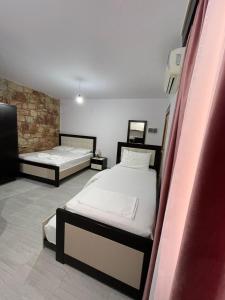 a bedroom with two beds in a room at Grand Seaview Apartments in Ksamil