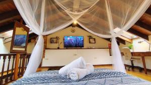 a bedroom with a bed with a canopy at La Casina de la Caleyona, Parres - Llanes in Llanes