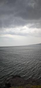a large body of water with a cloudy sky at Ithaca in Perdika
