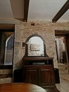 a room with a stone wall with a mirror at Mani Fort Charabos in Stavríon +50 photos