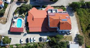 an overhead view of a large house with an orange roof at Pansion Comfort Sidro in Novalja