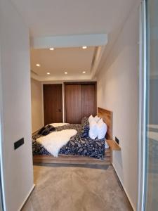 a bedroom with a bed with a wooden head board at Bella Vista MEHDIA in Kenitra