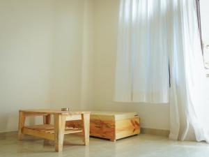 a room with a table and a bench and a window at Mama Killa Studio,1BHK,Apartment in Pushkar