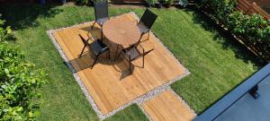 an overhead view of a wooden deck with a table and chairs at Forest Hill Apartment, near Ljubljana in Dol pri Ljubljani
