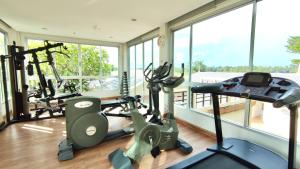 a gym with two treadmills and two ellipticals at Family House Casa Seaside Rayong in Ban Chak Phai
