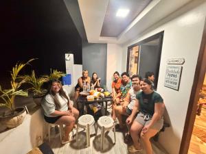 a group of people sitting in a room at 3Vhin Transient House in Sampong