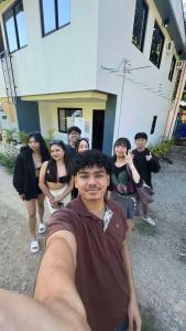 a group of people standing in front of a building at 3Vhin Transient House in Sampong