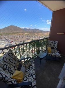 a balcony with a view of a city at A beautiful apartment with 3 bedrooms and 2 bathrooms for 6 people in Coquimbo