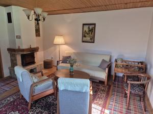 a living room with a couch and a table at Chata Monika in Prosiek