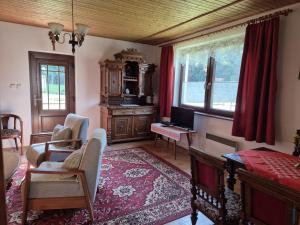 a living room with a desk and a computer in it at Chata Monika in Prosiek