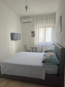 Letto o letti in una camera di Affittacamere Casa Flora