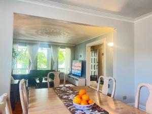 a dining room table with a bowl of oranges on it at Elegant 6BR Grand Villa in Highland Hill in Toronto