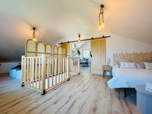 a bedroom with a bed and a crib at Cocon Savoyard - Vues Alpes - 2 king size - Rando & VTT - Parking in Albertville