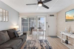 a living room with a couch and a ceiling fan at 301 Ocean Ave, Unit 206 - The Harbor Light in North Wildwood