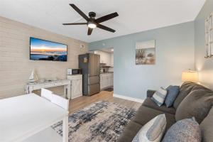 a living room with a couch and a ceiling fan at 301 Ocean Ave, Unit 206 - The Harbor Light in North Wildwood