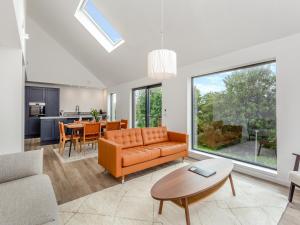 an open living room with a couch and a table at Faodail in Portree
